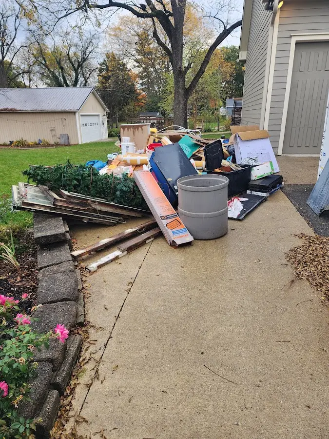 Dumpster being loaded with debris for Estate Cleanout Dumpster Rental in Charlotte